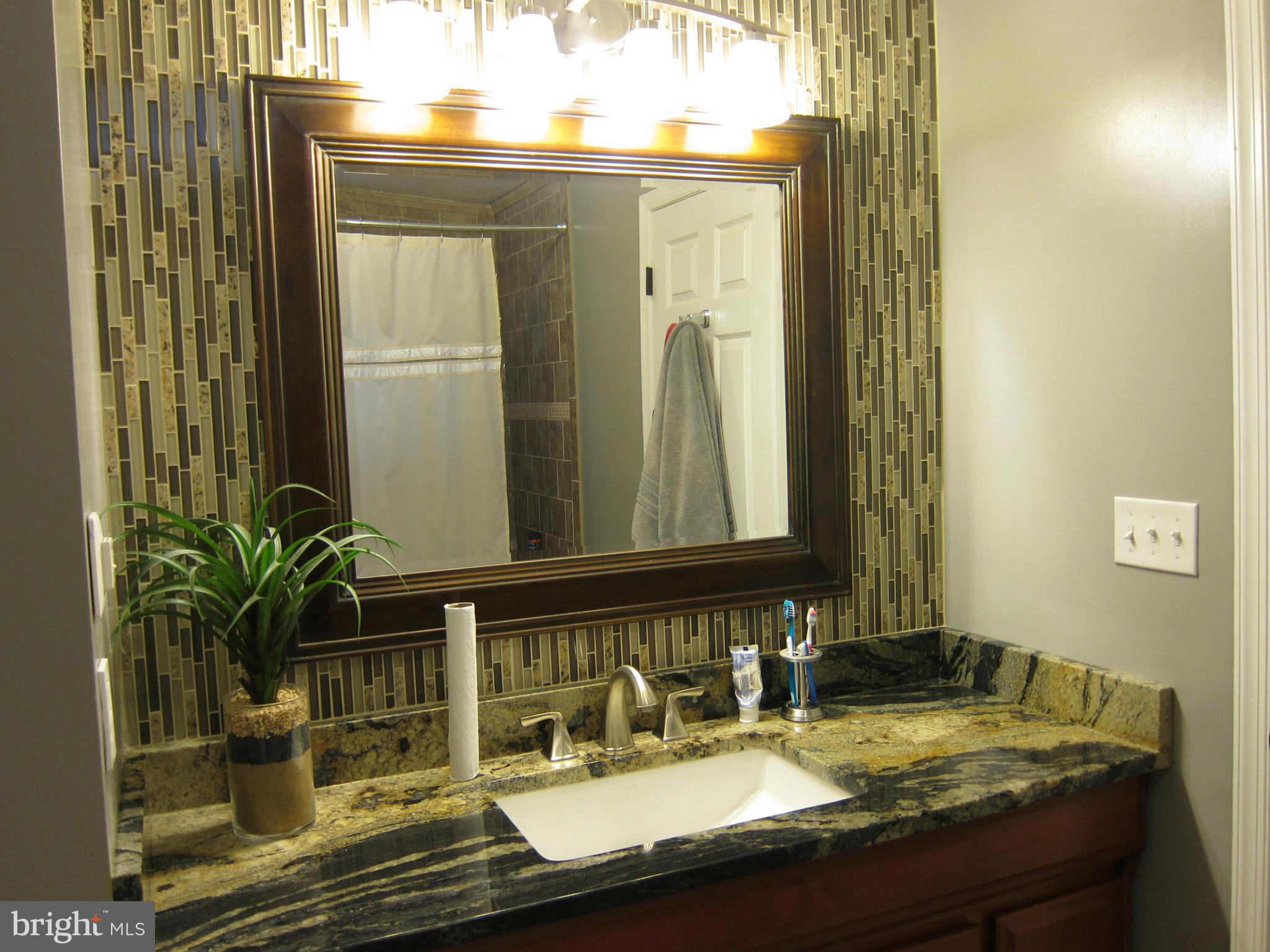 5723 Turner Road Broad Run, VA 20137 - Photo 17 of 29 Custom vanity and tiled accent wall
