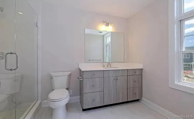 a bathroom with a toilet a sink a vanity and mirror