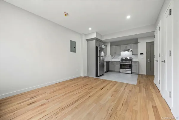 a view of empty room with wooden floor