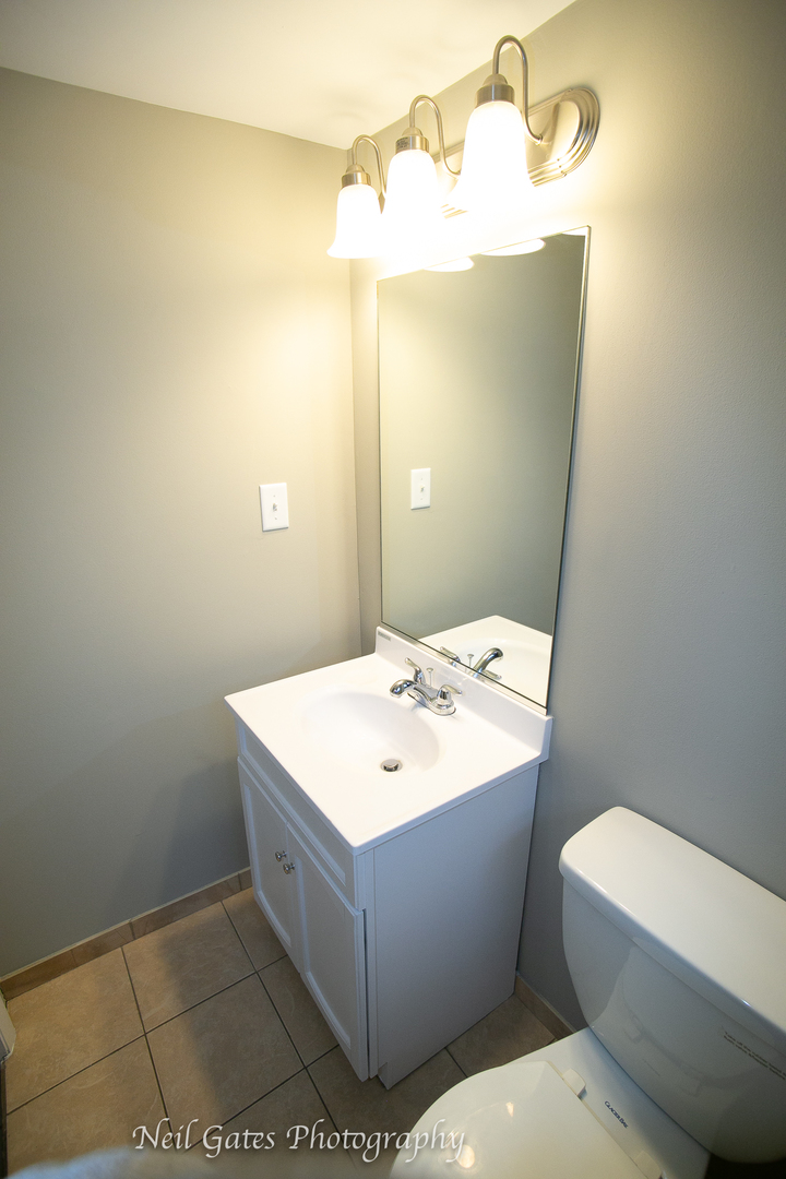 1459 West 187th Street Homewood, IL 60430 - Photo 26 of 32 a bathroom with a sink a toilet and mirror