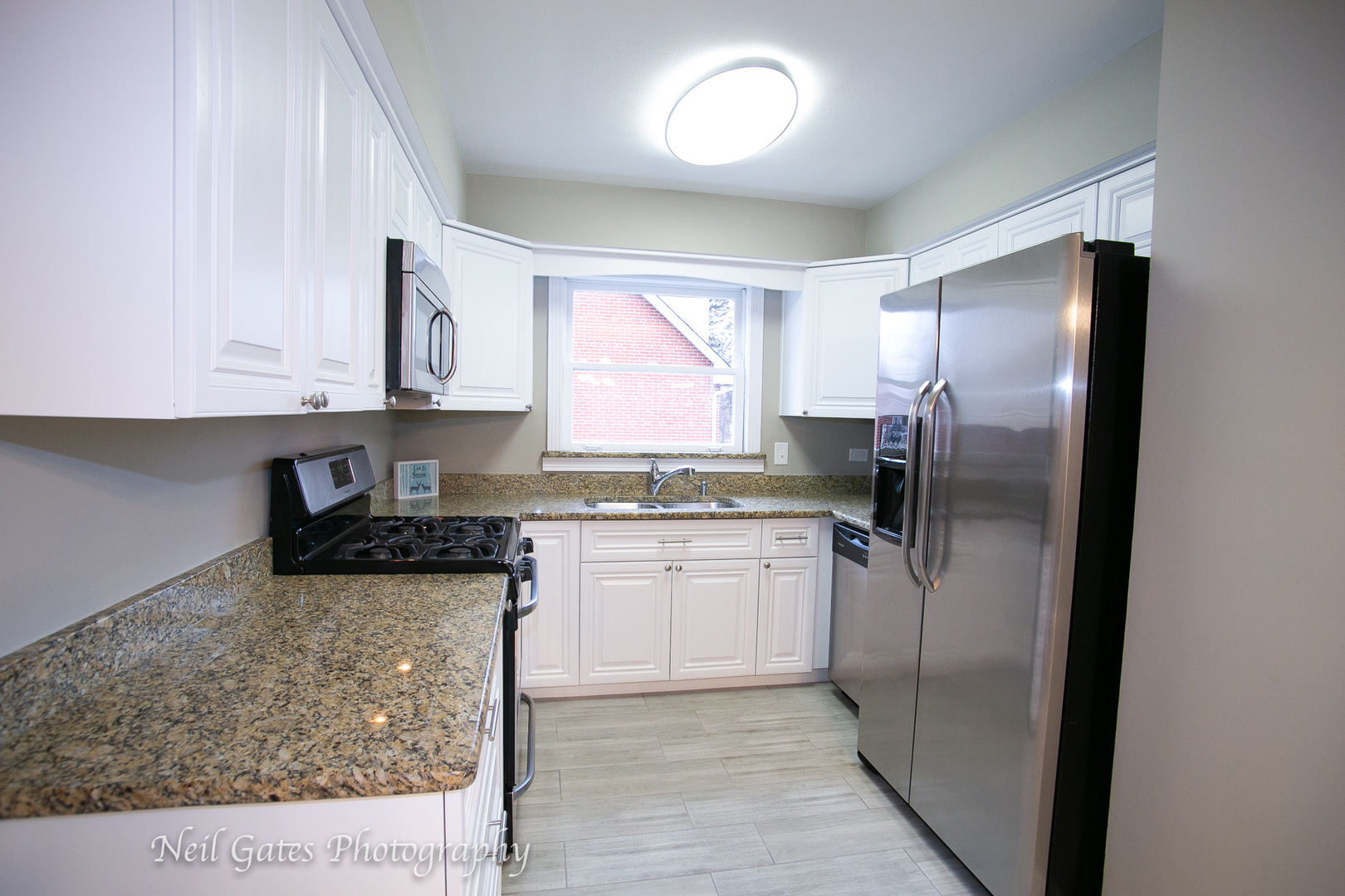 1459 West 187th Street Homewood, IL 60430 - Photo 6 of 32 a kitchen with stainless steel appliances granite countertop a refrigerator sink and cabinets