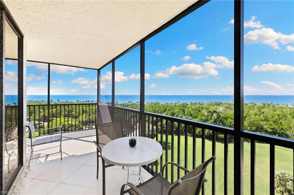 11 Bluebill Avenue, Unit 702 Naples, FL 34108 - Photo 21 of 35 a view of a balcony with chair and glass door