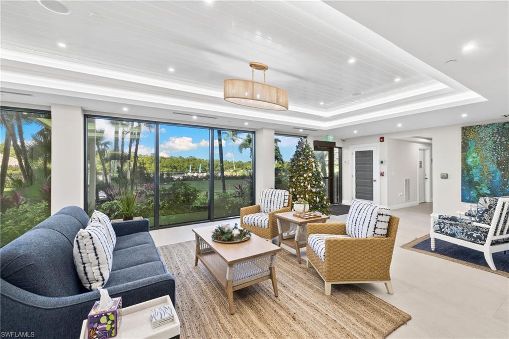 11 Bluebill Avenue, Unit 702 Naples, FL 34108 - Photo 25 of 35 a living room with furniture and a large window