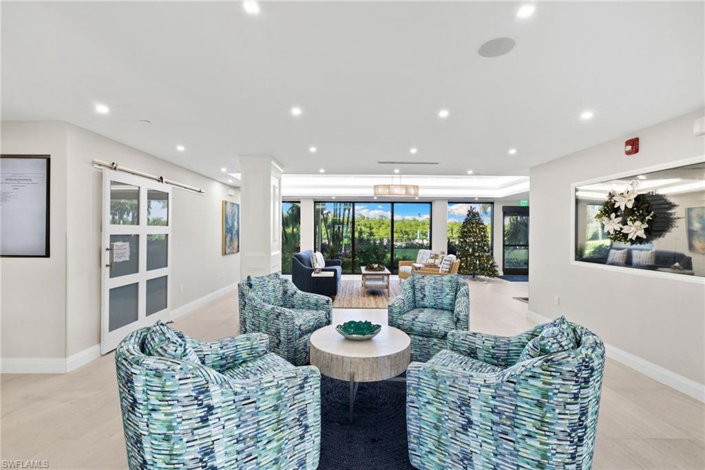 11 Bluebill Avenue, Unit 702 Naples, FL 34108 - Photo 26 of 35 a living room with furniture and a large window