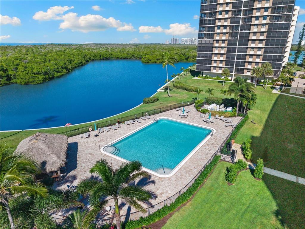 11 Bluebill Avenue, Unit 702 Naples, FL 34108 - Photo 31 of 35 an aerial view of a pool a yard patio and outdoor seating