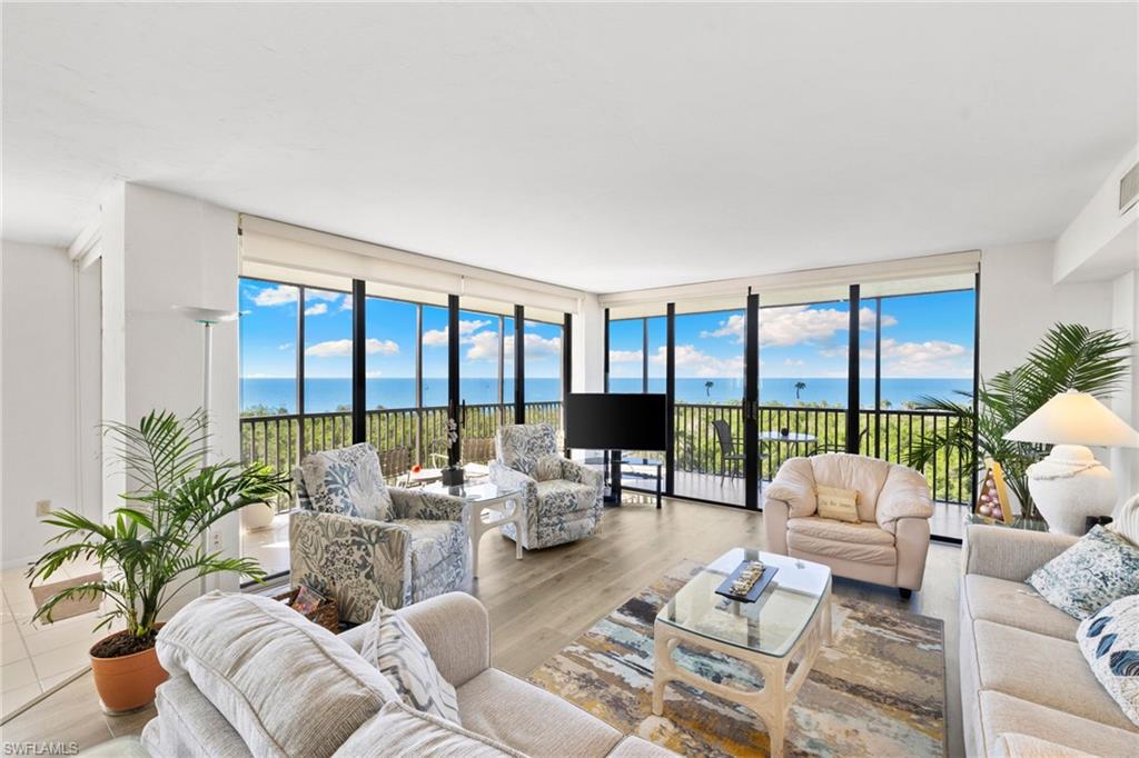 11 Bluebill Avenue, Unit 702 Naples, FL 34108 - Photo 6 of 35 a living room with furniture and a large window