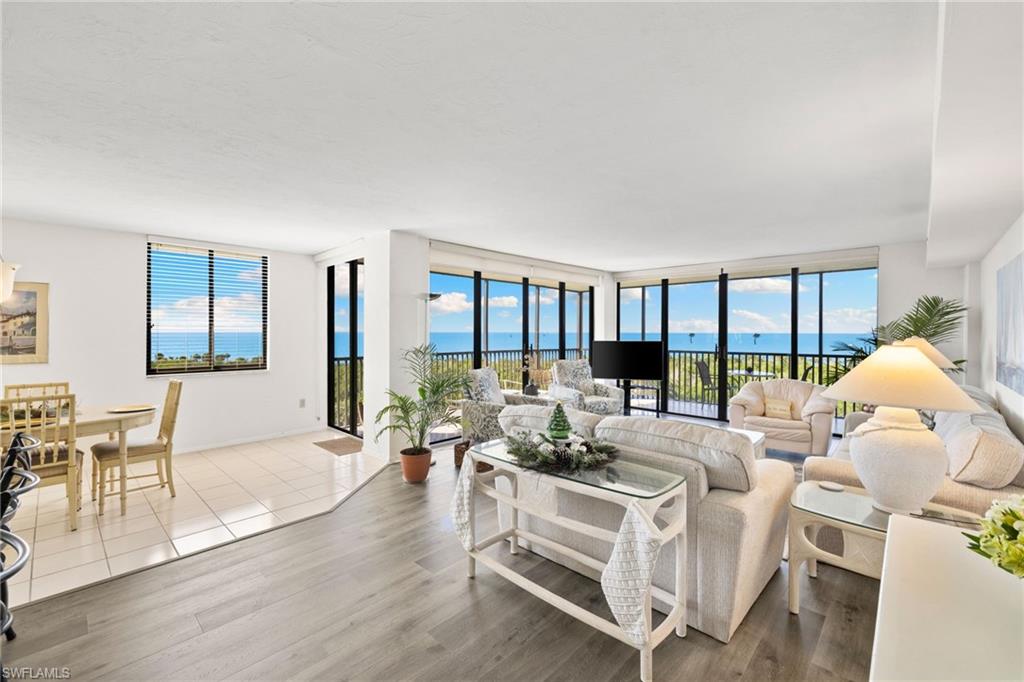 11 Bluebill Avenue, Unit 702 Naples, FL 34108 - Photo 7 of 35 a living room with furniture and a large window