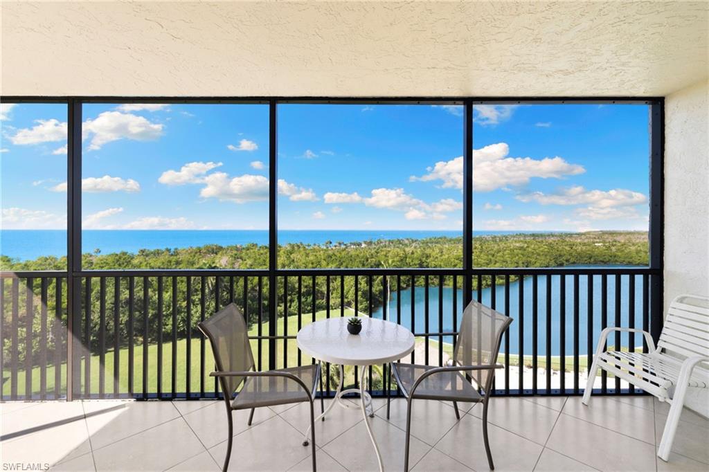 11 Bluebill Avenue, Unit 702 Naples, FL 34108 - Photo 10 of 35 a view of a balcony with lake view and wooden floor
