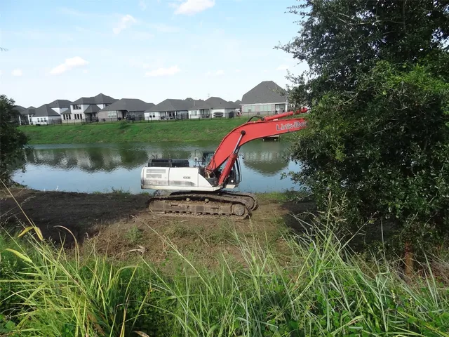 an aerial view of a house with a yard and lake view