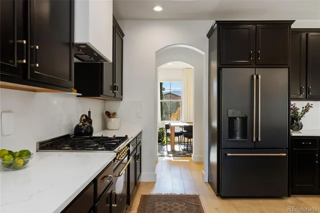a kitchen with a refrigerator and a stove top oven
