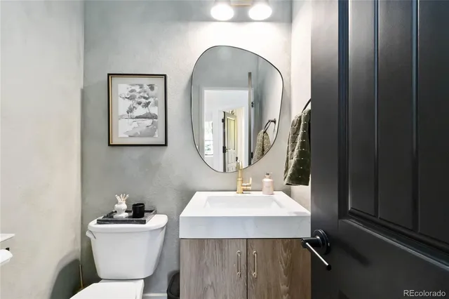 a bathroom with a toilet sink and mirror