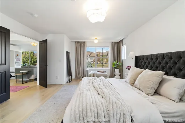 a bedroom with a large bed and a large window