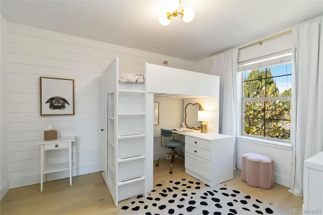 a room with a window and a dresser