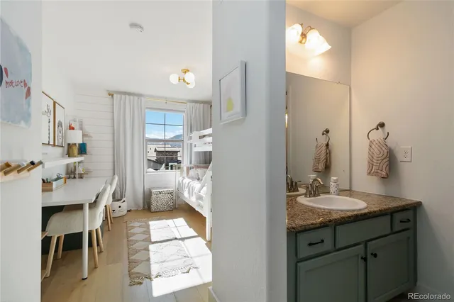 a en suite bathroom with a sink double vanity and a mirror