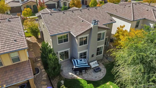 a view of a house with brick walls and potted plants