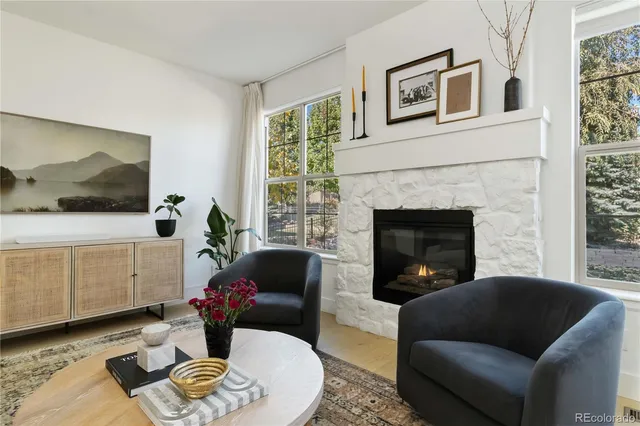 a living room with furniture a flat screen tv and a fireplace