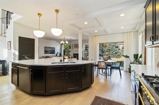 a kitchen with a stove and chairs