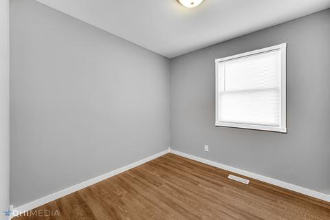 249 Rockhurst Road Bolingbrook, IL 60440 - Photo 11 of 18 wooden floor in an empty room with a window