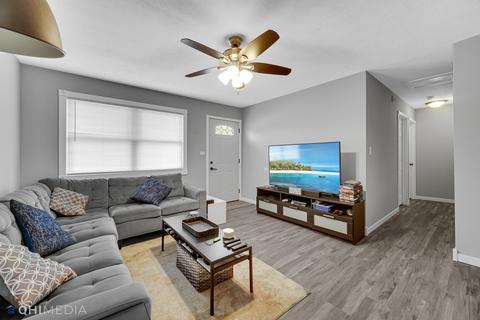 249 Rockhurst Road Bolingbrook, IL 60440 - Photo 3 of 18 a living room with furniture a window and a flat screen tv