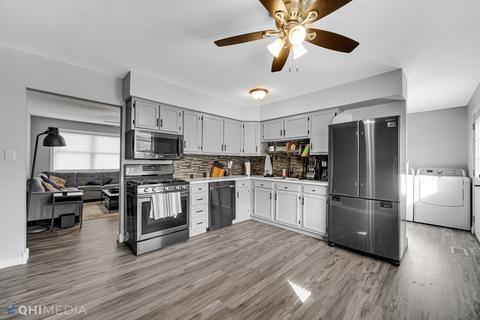249 Rockhurst Road Bolingbrook, IL 60440 - Photo 5 of 18 a kitchen with a refrigerator cabinets and wooden floor