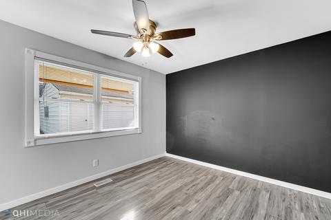 249 Rockhurst Road Bolingbrook, IL 60440 - Photo 8 of 18 a view of an empty room with wooden floor and a window