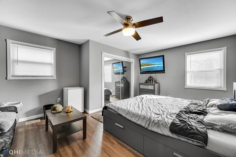 249 Rockhurst Road Bolingbrook, IL 60440 - Photo 10 of 18 a bedroom with a bed and wooden floor