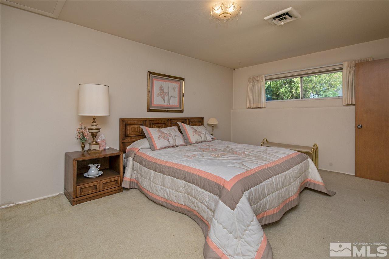 3360 Marthiam Avenue Reno, NV 89509 - Photo 11 of 39 a bedroom with a bed and a lamp on dresser