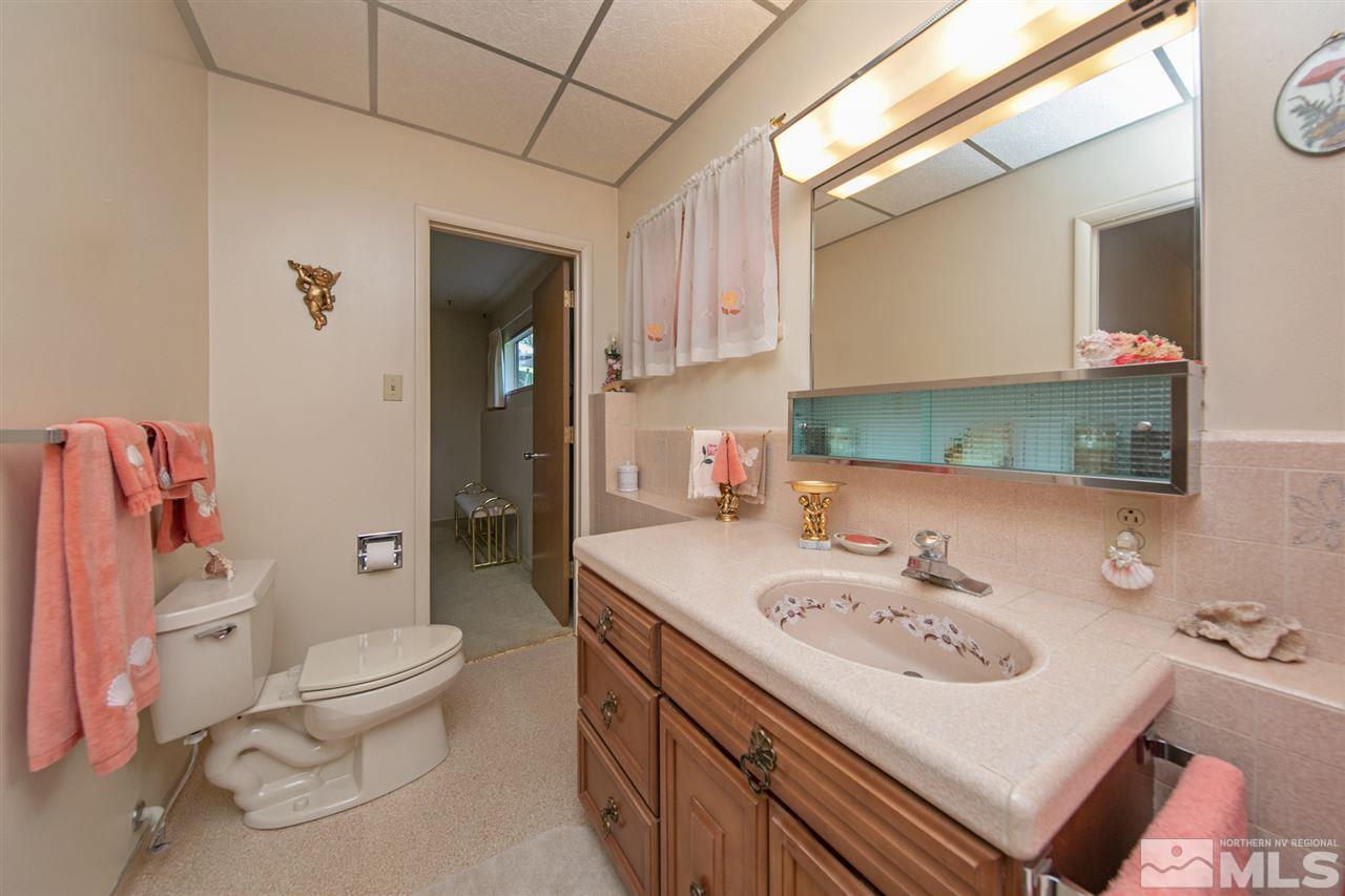 3360 Marthiam Avenue Reno, NV 89509 - Photo 14 of 39 a bathroom with a sink toilet and mirror