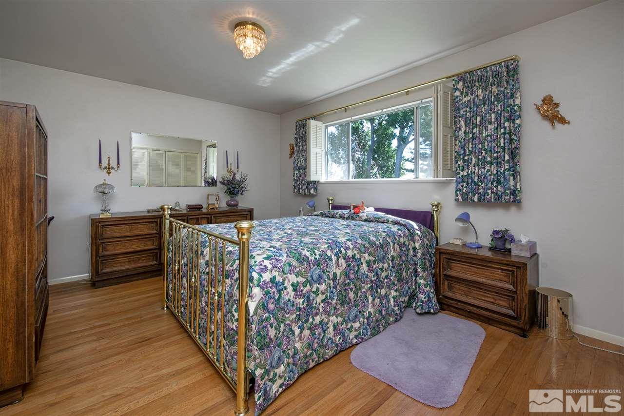 3360 Marthiam Avenue Reno, NV 89509 - Photo 17 of 39 a bed sitting in a bedroom next to a window
