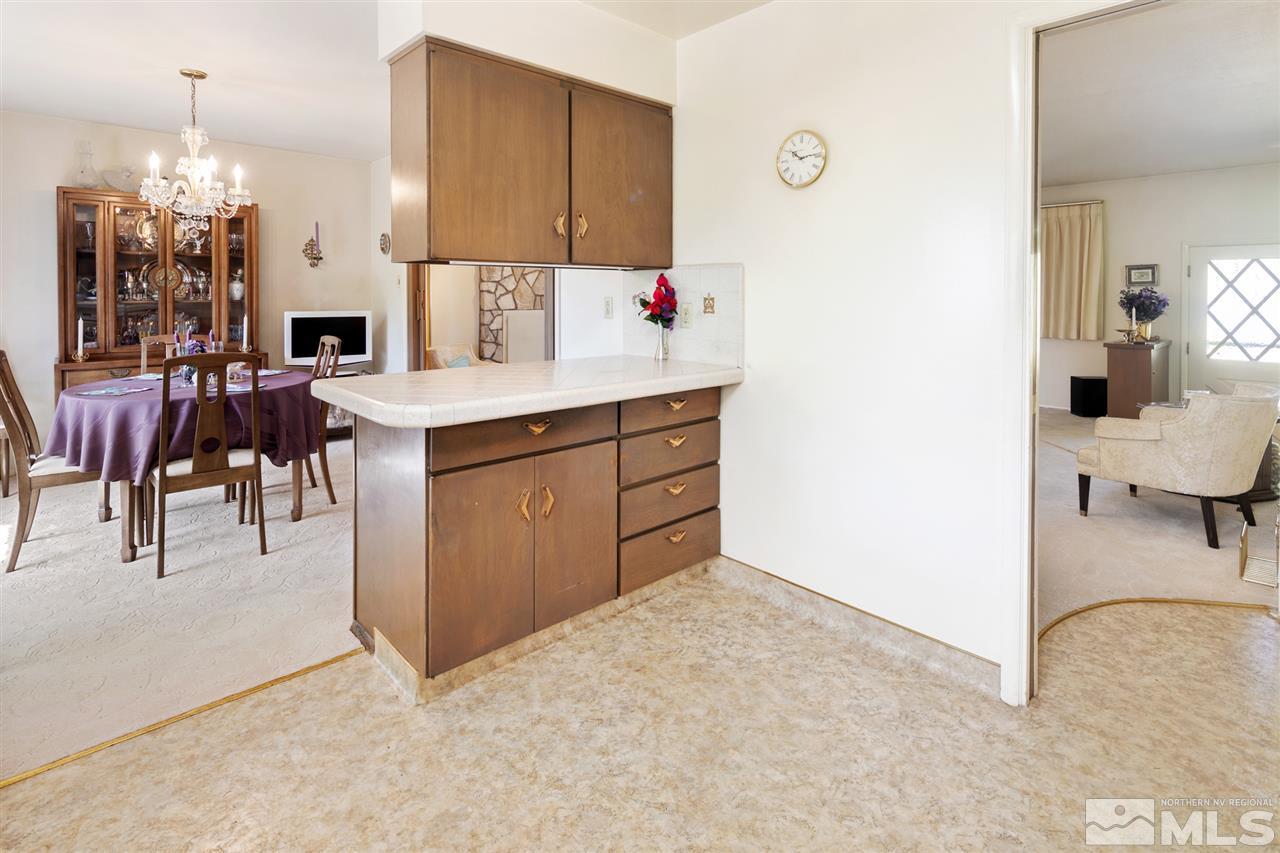 3360 Marthiam Avenue Reno, NV 89509 - Photo 3 of 39 a view of kitchen with kitchen island dining table and chairs