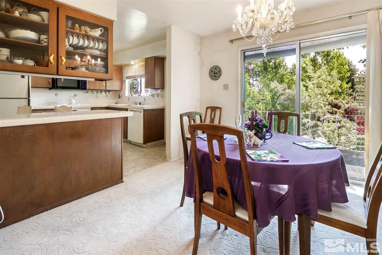 3360 Marthiam Avenue Reno, NV 89509 - Photo 4 of 39 a dining room with furniture a chandelier and window