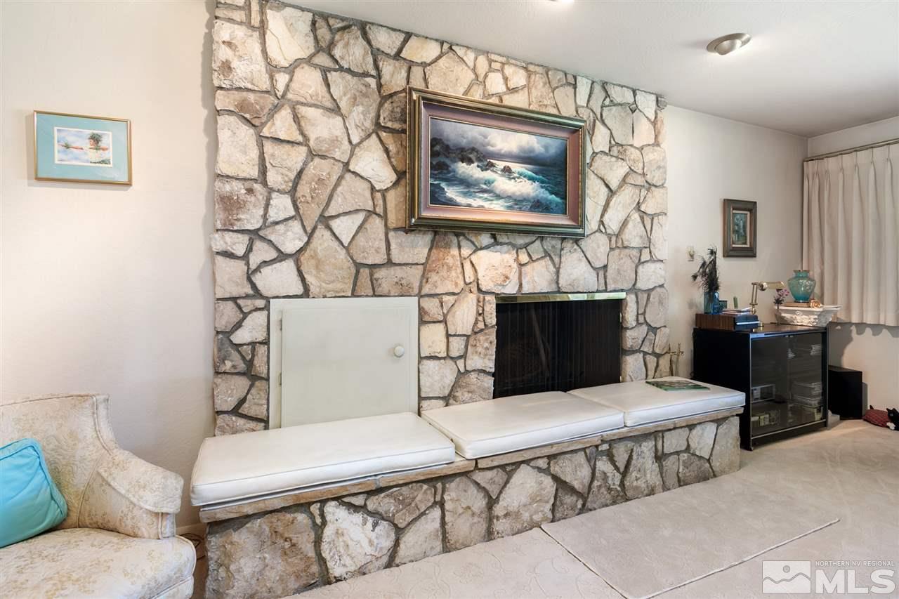 3360 Marthiam Avenue Reno, NV 89509 - Photo 8 of 39 a living room with furniture a flat screen tv and a fireplace