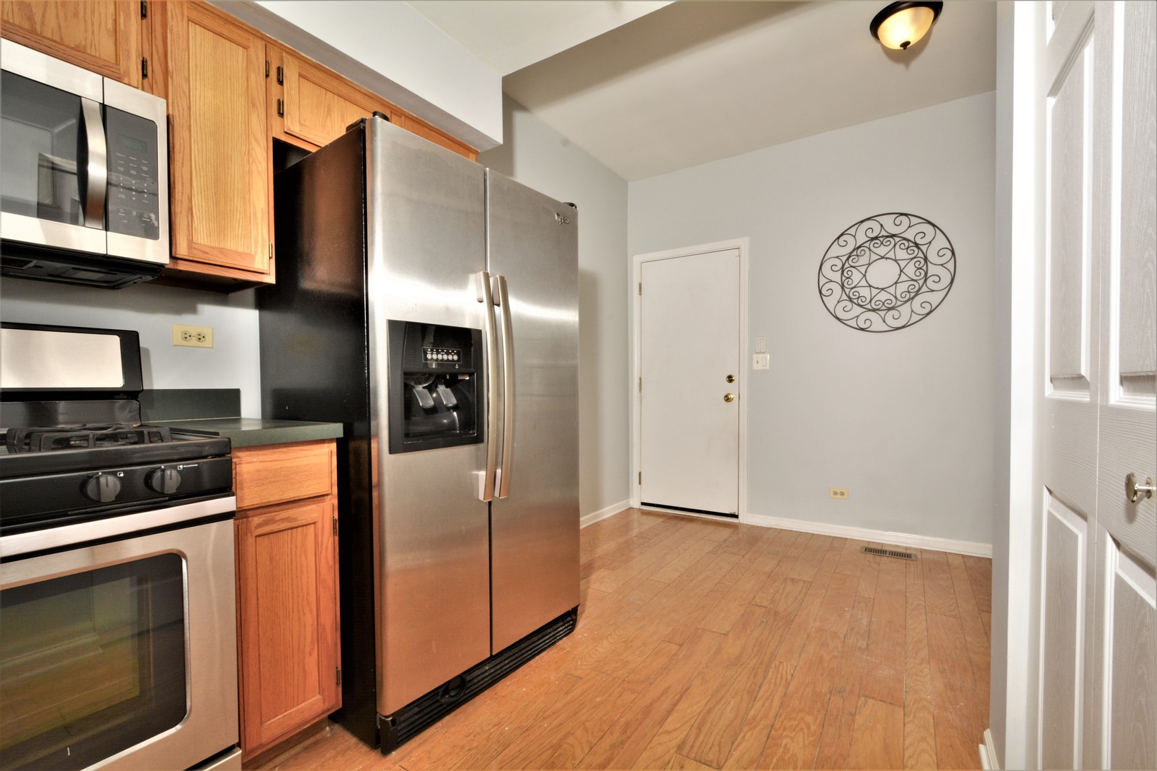 8187 Ripple Ridge Darien, IL 60561 - Photo 3 of 21 a view of a kitchen with stainless steel appliances granite countertop a stove and a refrigerator