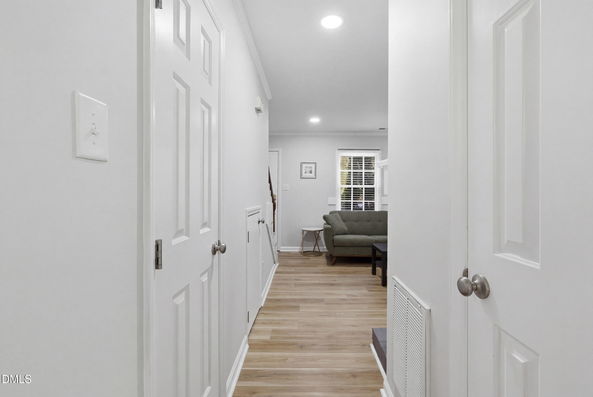 725 Charleston Road Raleigh, NC 27606 - Photo 12 of 27 a view of a hallway with a livingroom and a bathroom with sink