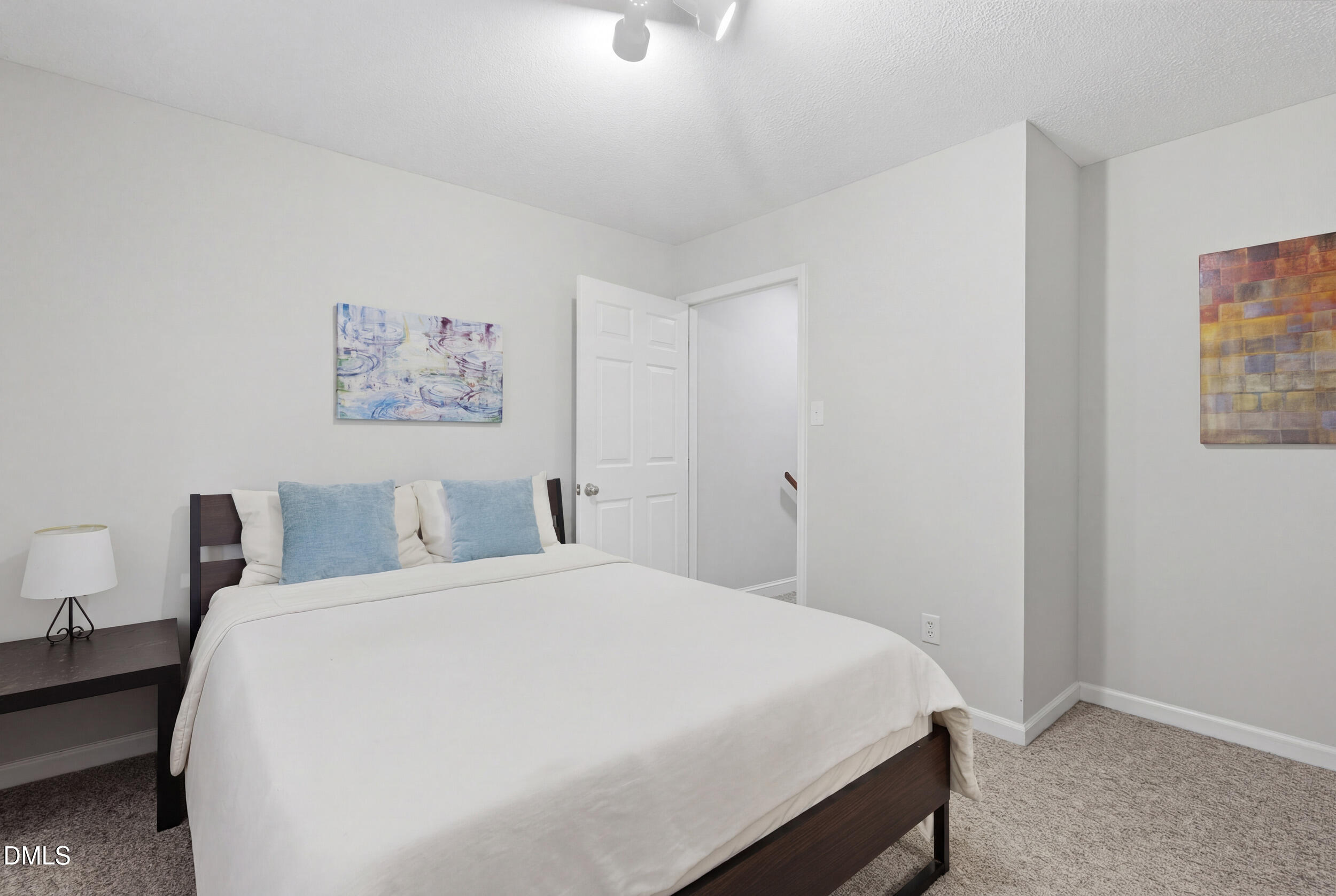 725 Charleston Road Raleigh, NC 27606 - Photo 15 of 27 a bedroom with a bed and a wall painting
