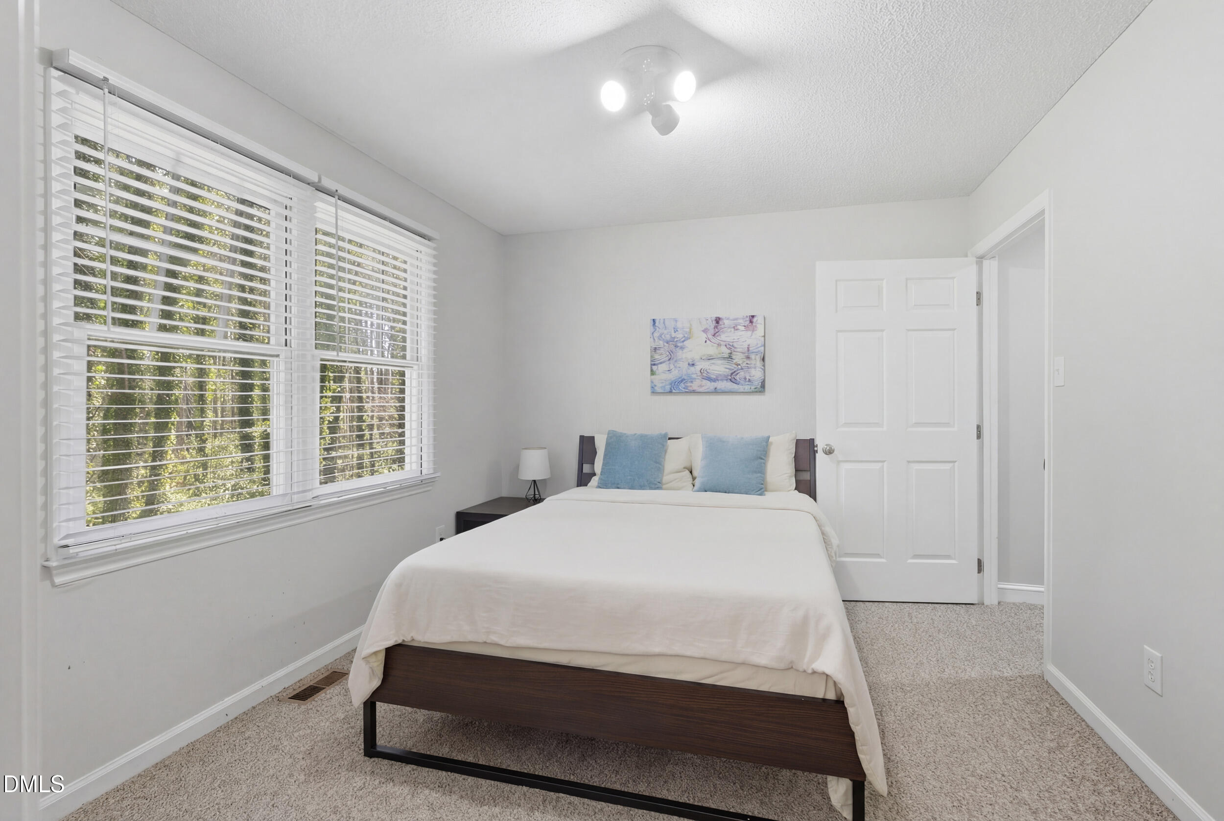 725 Charleston Road Raleigh, NC 27606 - Photo 16 of 27 a bedroom with a bed and a window