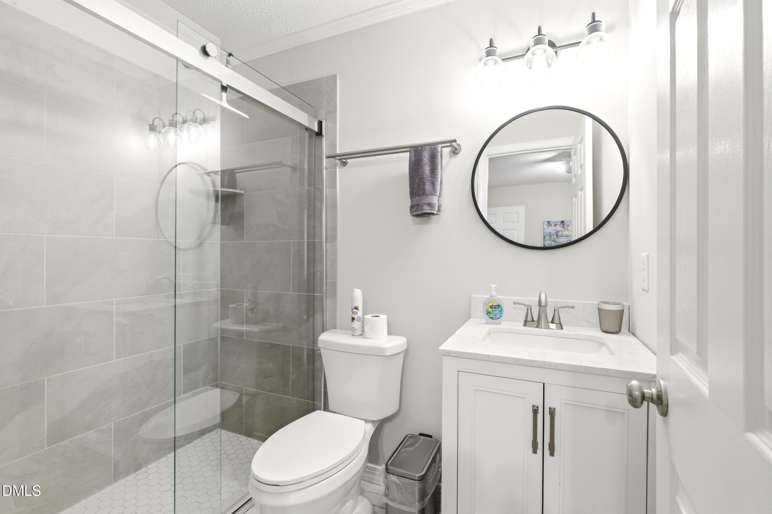 725 Charleston Road Raleigh, NC 27606 - Photo 17 of 27 a bathroom with a toilet sink vanity granite and shower