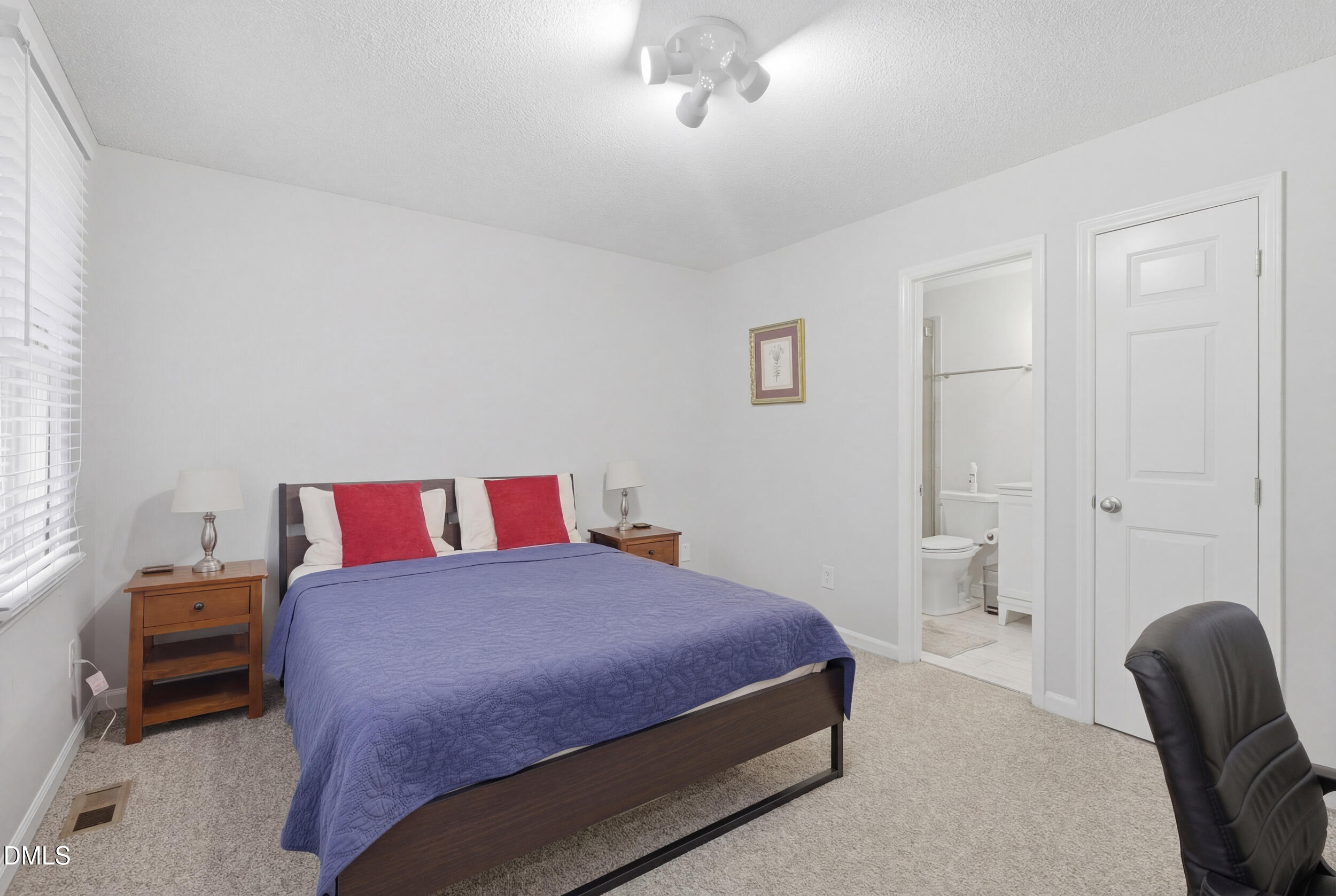 725 Charleston Road Raleigh, NC 27606 - Photo 19 of 27 a bedroom with a bed and a chair