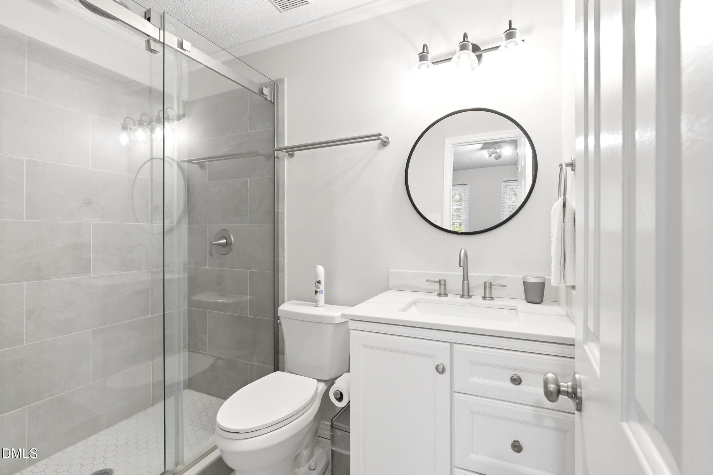 725 Charleston Road Raleigh, NC 27606 - Photo 22 of 27 a bathroom with a toilet sink vanity and mirror