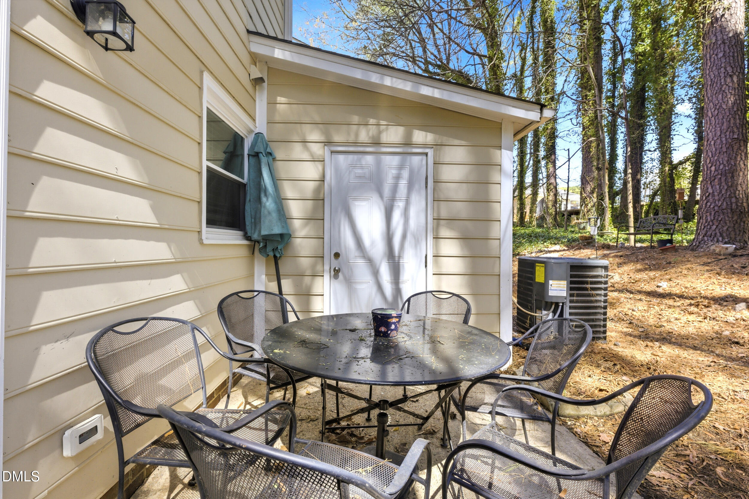 725 Charleston Road Raleigh, NC 27606 - Photo 24 of 27 a table and chairs in front of a house