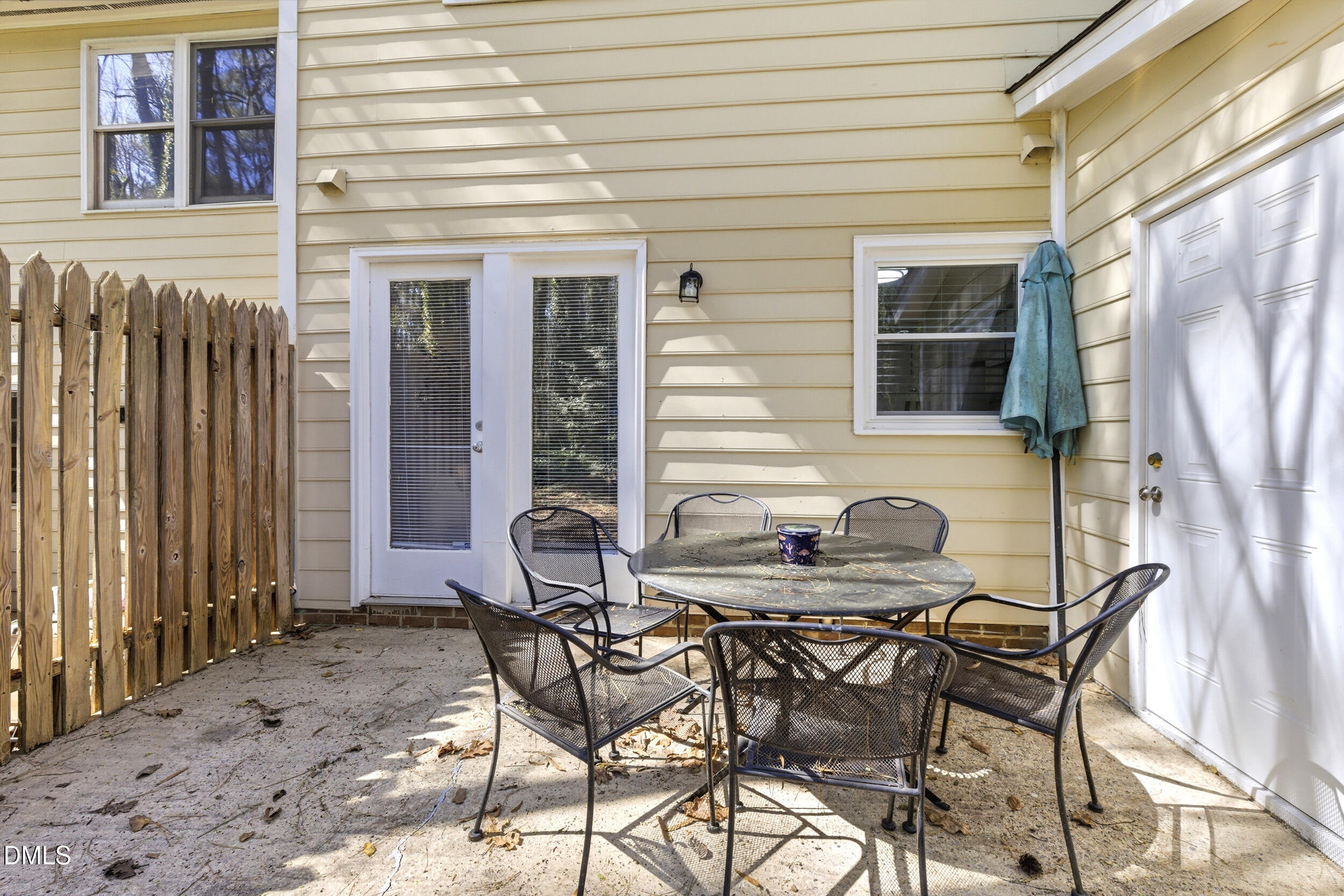 725 Charleston Road Raleigh, NC 27606 - Photo 25 of 27 a view of a patio with table and chairs and potted plants