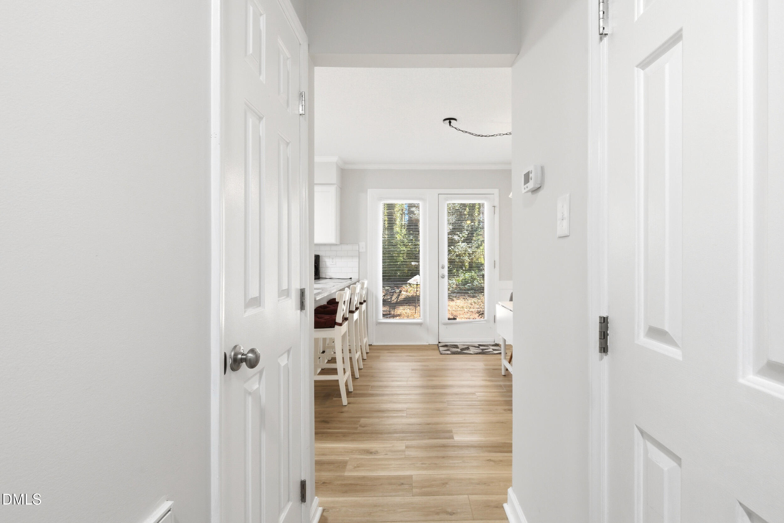 725 Charleston Road Raleigh, NC 27606 - Photo 6 of 27 a view of a hallway with wooden floor and a living room