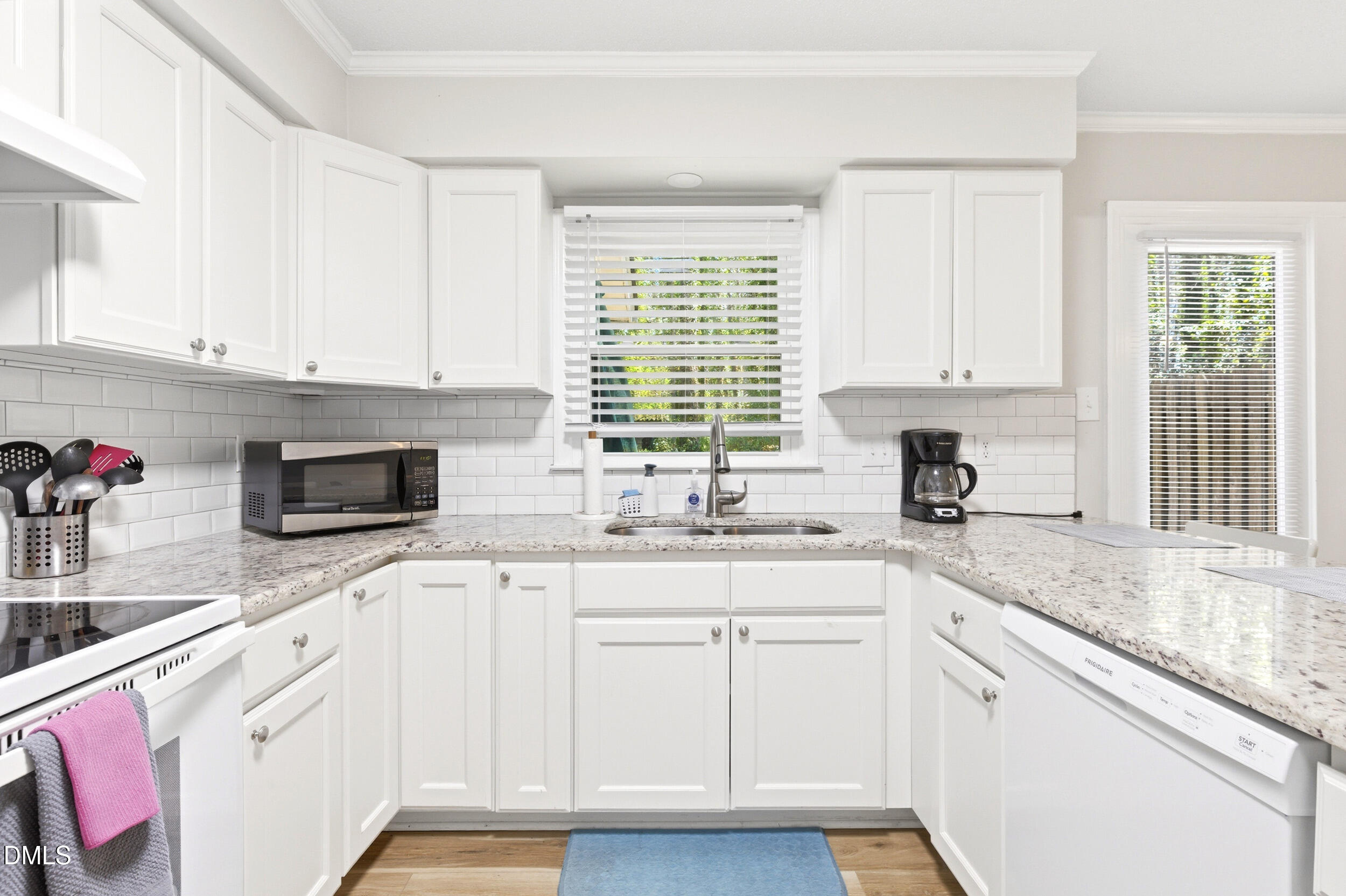 725 Charleston Road Raleigh, NC 27606 - Photo 7 of 27 a kitchen with granite countertop white cabinets sink and window