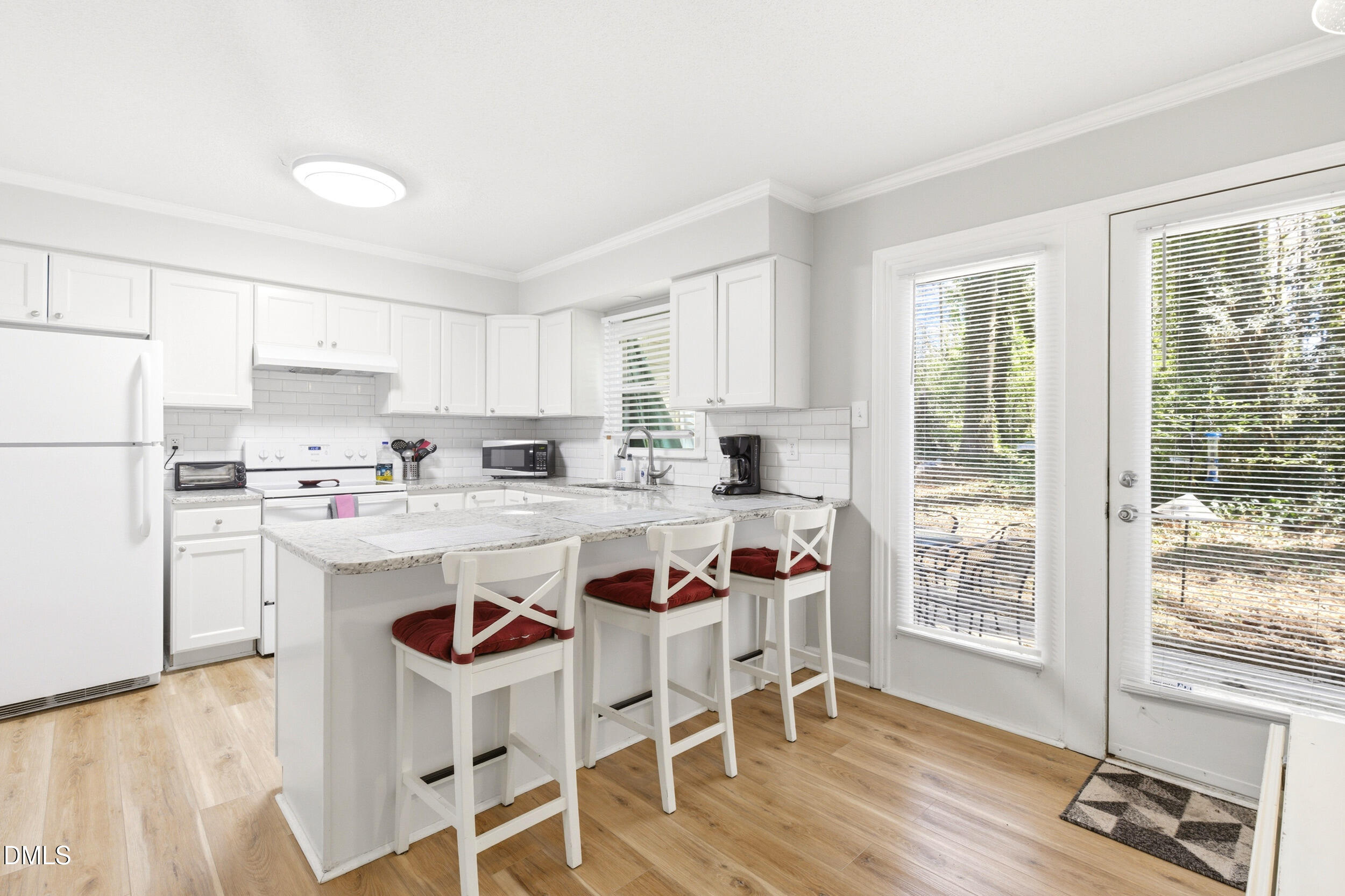 725 Charleston Road Raleigh, NC 27606 - Photo 8 of 27 a kitchen with stainless steel appliances granite countertop a white cabinets and a refrigerator