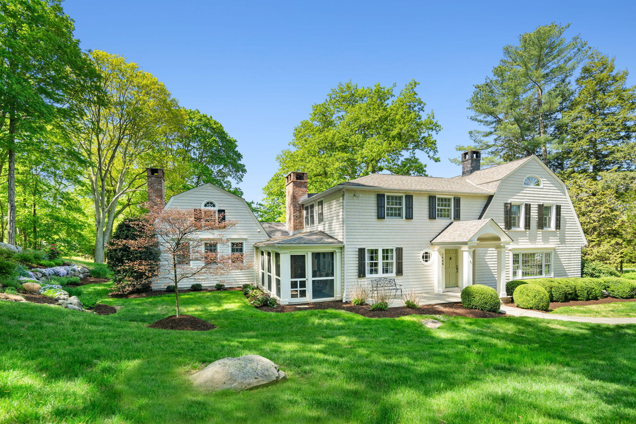 1466 Ponus Ridge Road New Canaan, CT 06840 - Photo 2 of 81 a front view of a house with a yard and trees