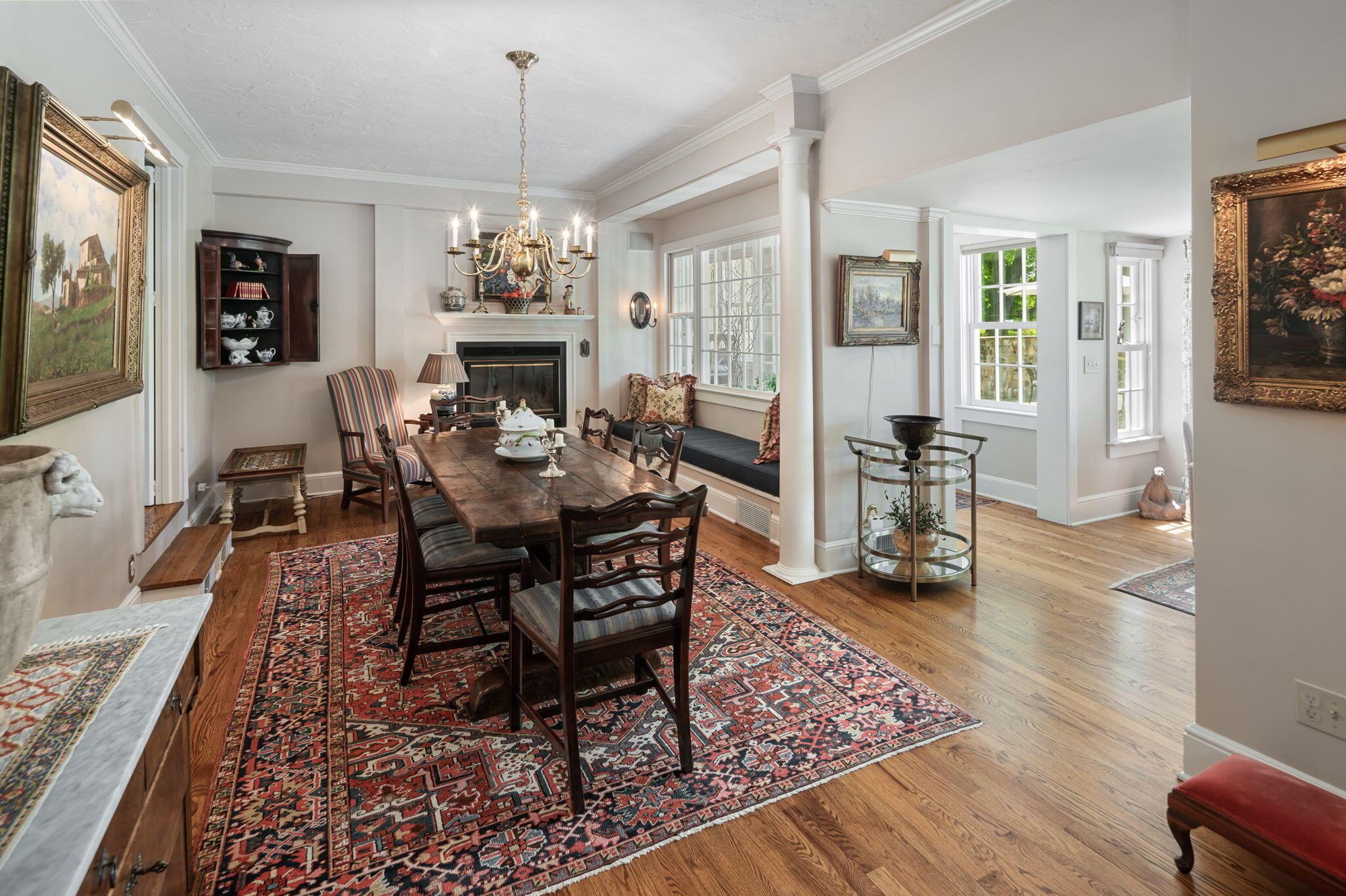 1466 Ponus Ridge Road New Canaan, CT 06840 - Photo 25 of 81 a dining room with wooden floor a chandelier a wooden table and chairs