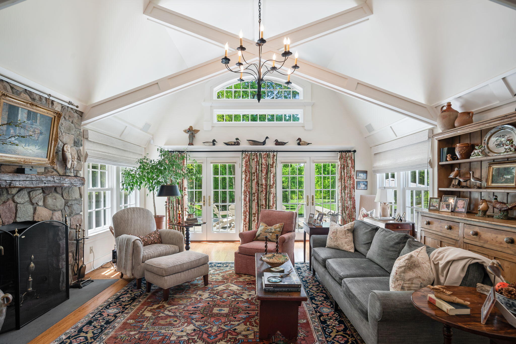 1466 Ponus Ridge Road New Canaan, CT 06840 - Photo 6 of 81 a living room with furniture a fireplace and a chandelier