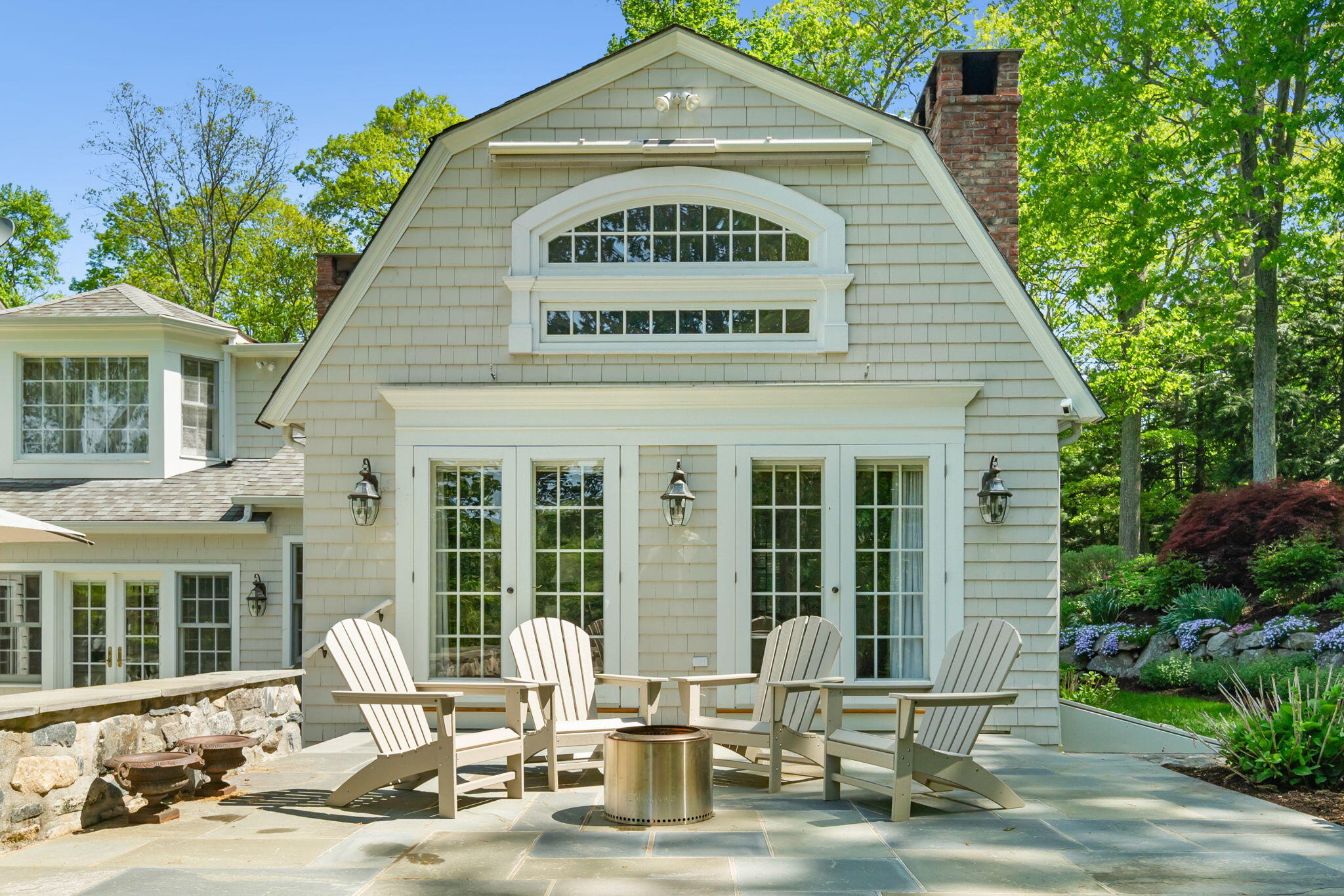 1466 Ponus Ridge Road New Canaan, CT 06840 - Photo 70 of 81 a front view of a house with garden and seating area