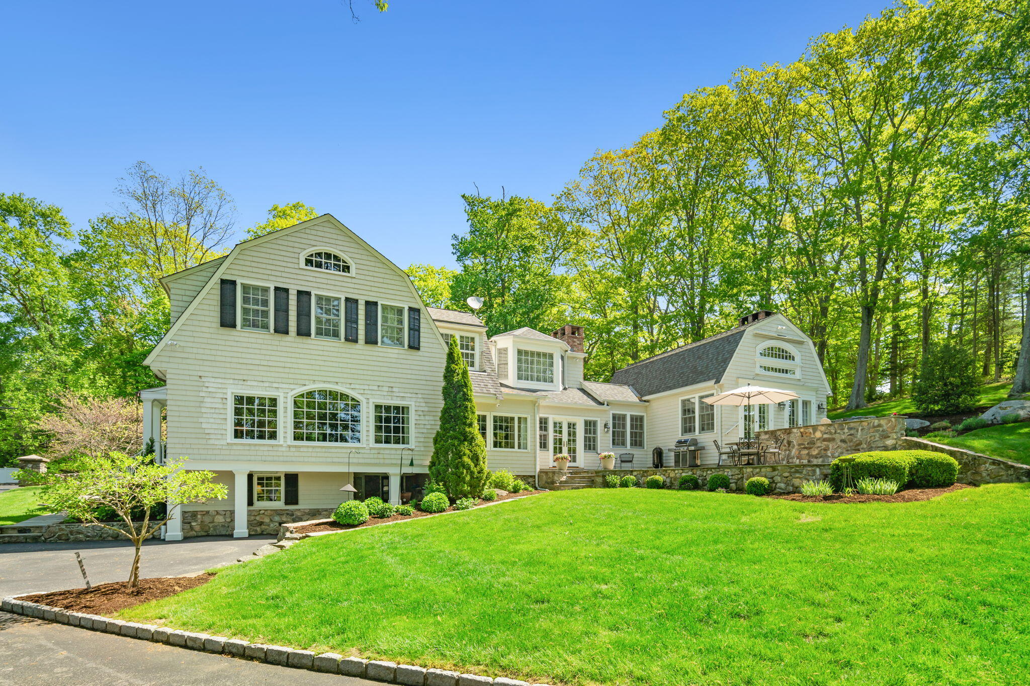 1466 Ponus Ridge Road New Canaan, CT 06840 - Photo 74 of 81 a front view of a house with a garden