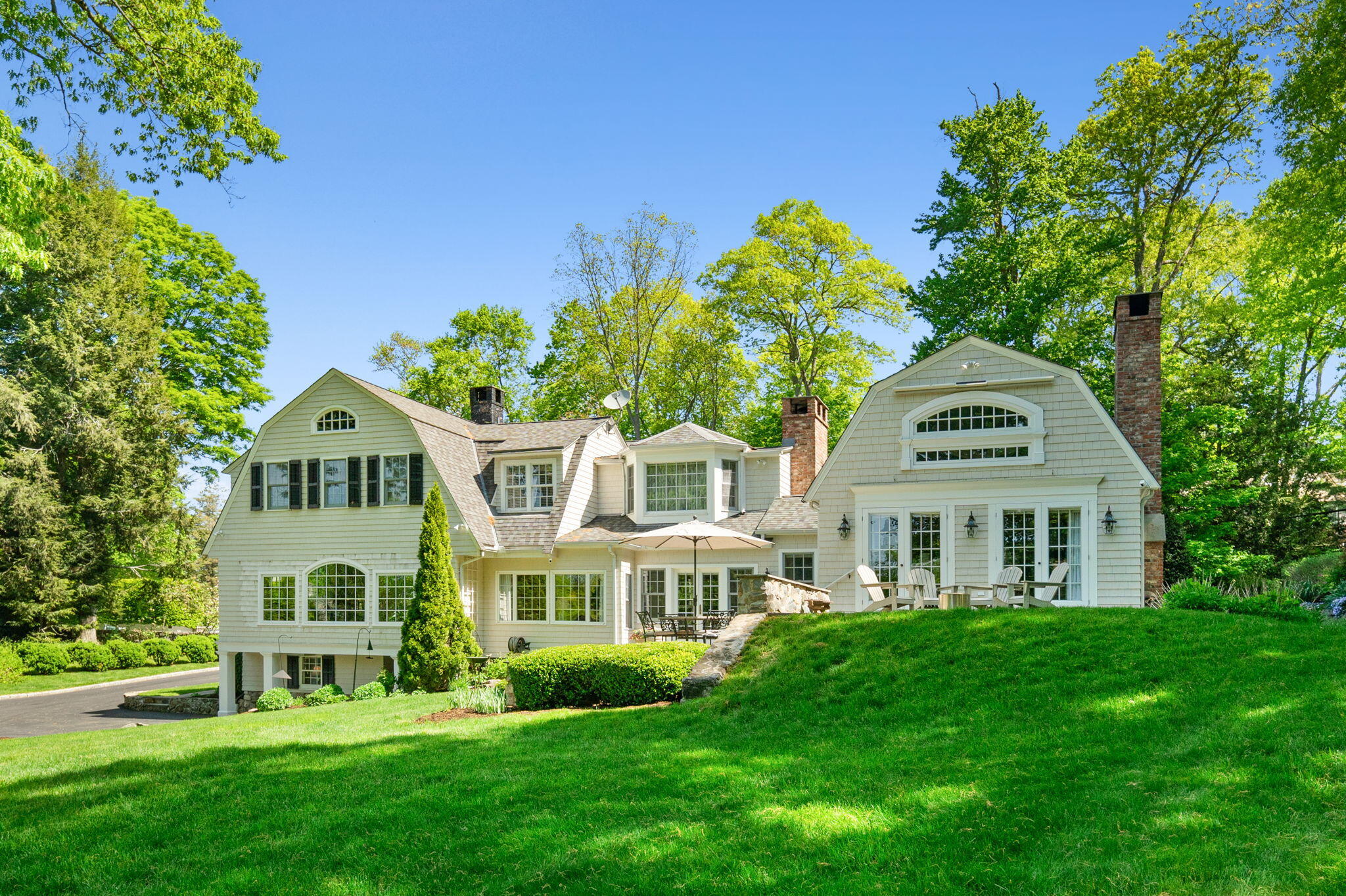 1466 Ponus Ridge Road New Canaan, CT 06840 - Photo 75 of 81 a front view of a house with a garden